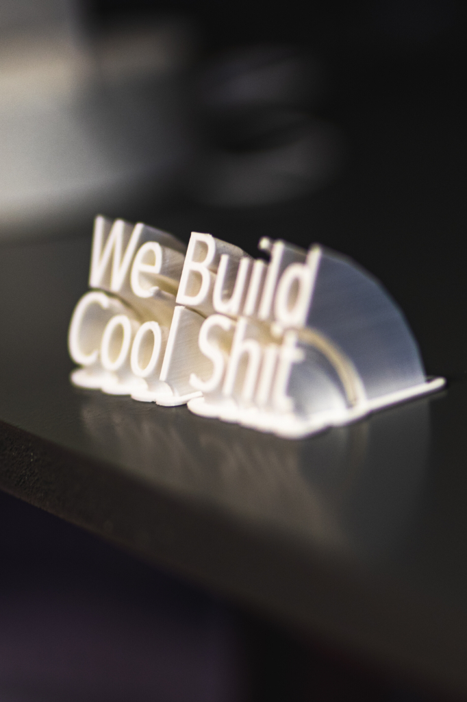3d printed we build cool shit sign