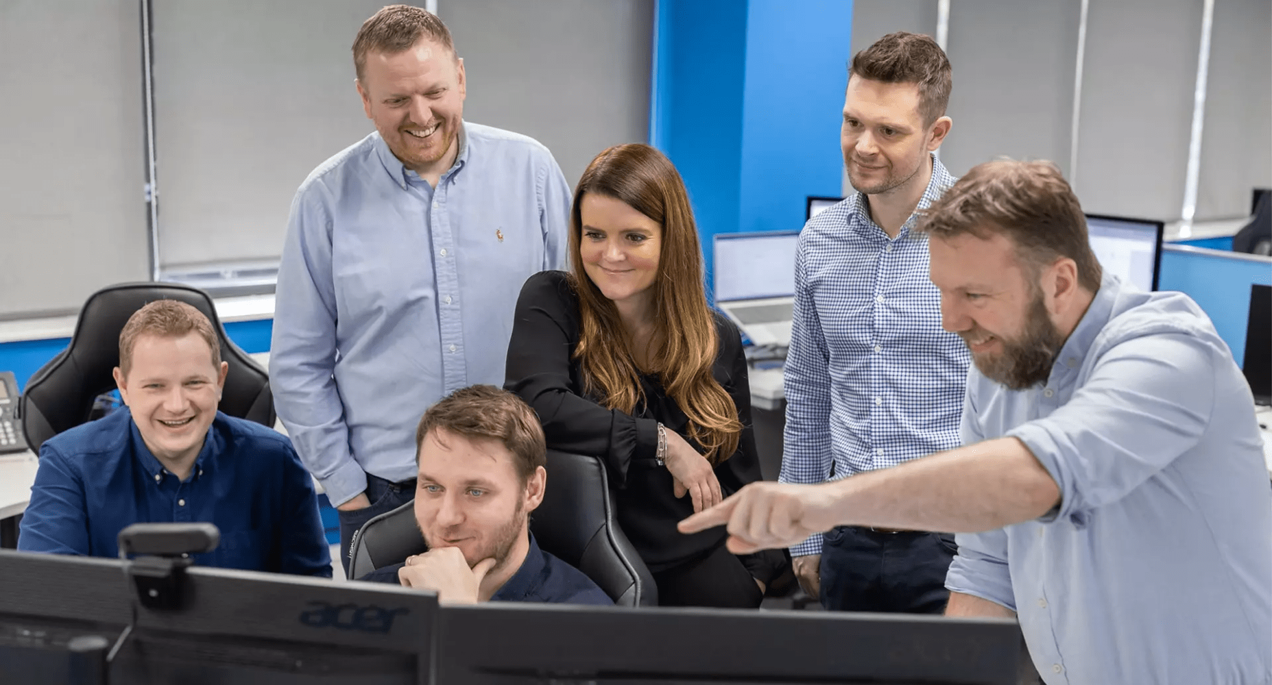 The HBP team gathered around a screen in their office.