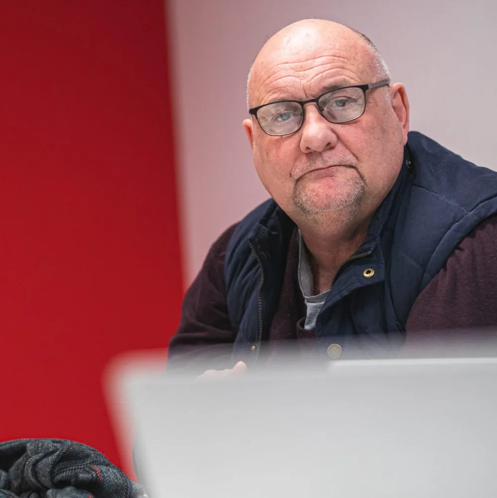 Paul looking at a laptop