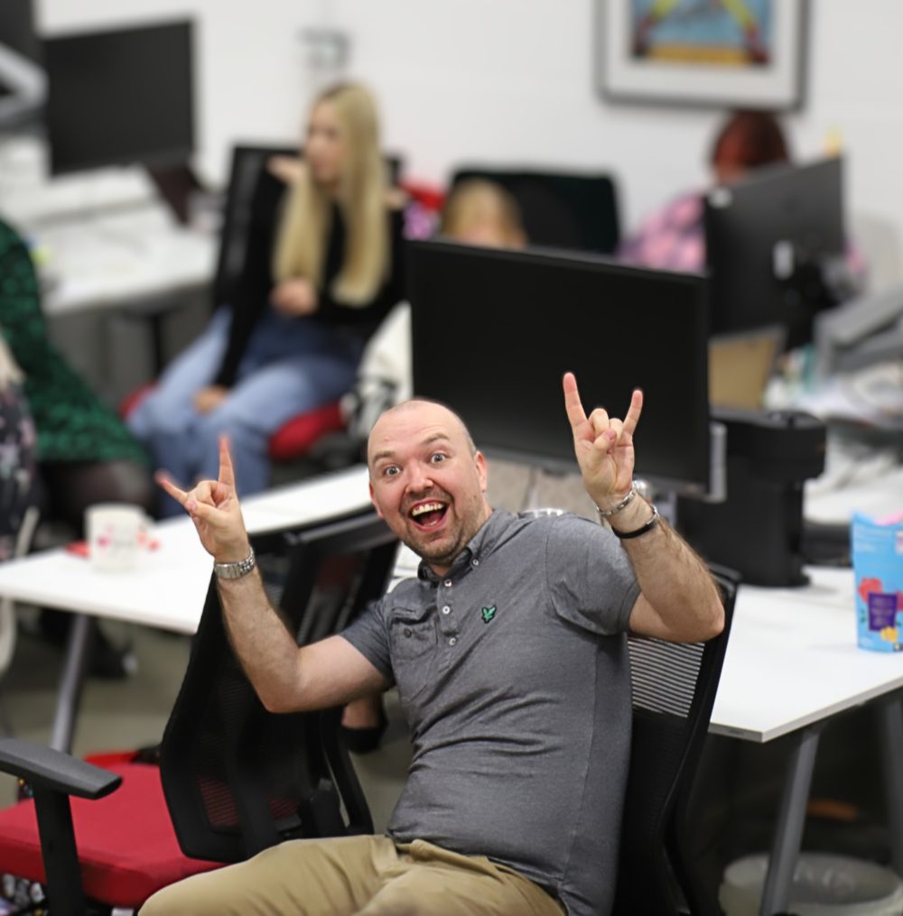 Paul 2 smiling at the camera whilst encouraging everyone to rock on