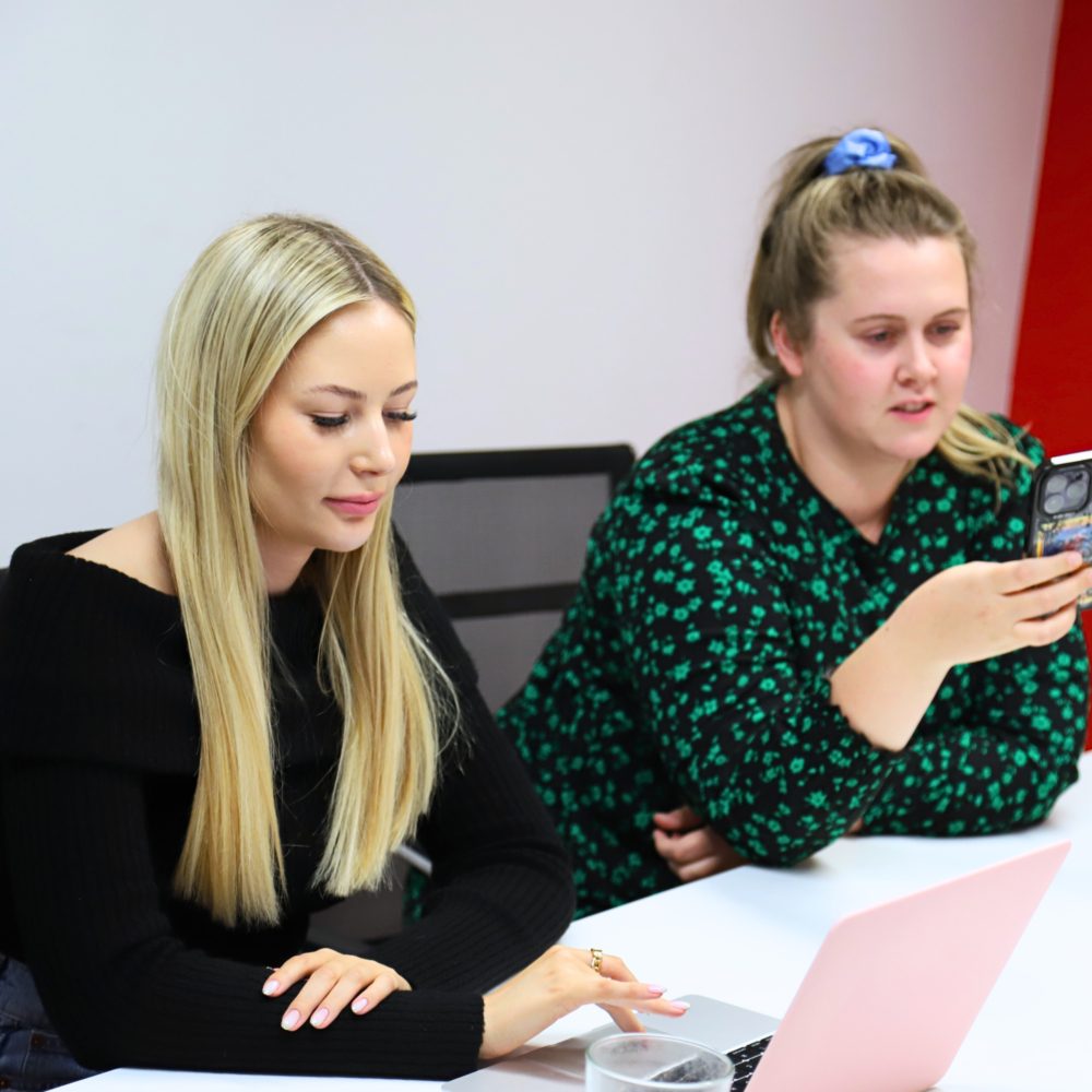 Becca and Cloud doing research using phones and macbooks