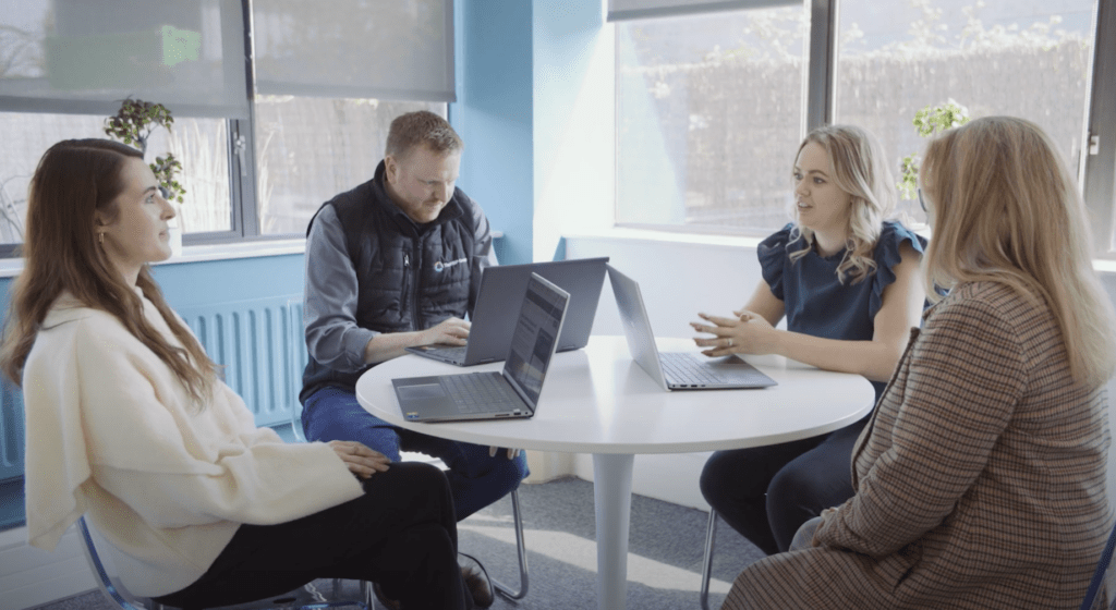 HBP Group team sat around a desk